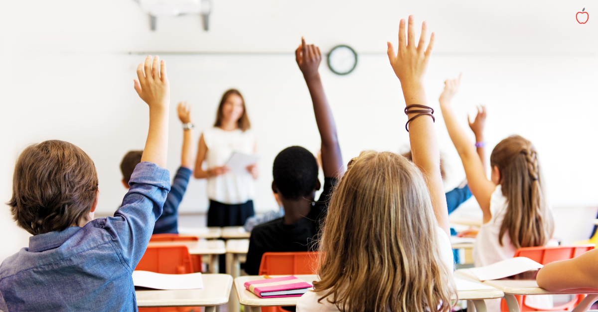 Charter School Classroom Students all raise hands